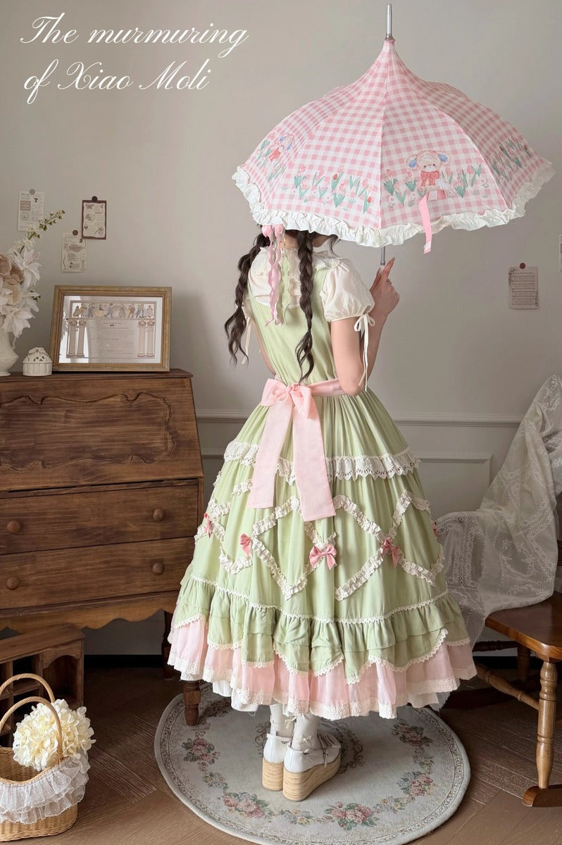 Person wearing a green and pink vintage-style dress with an umbrella indoors.