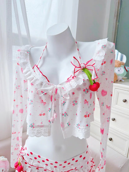 White lace top with red floral details on a mannequin against a light background
