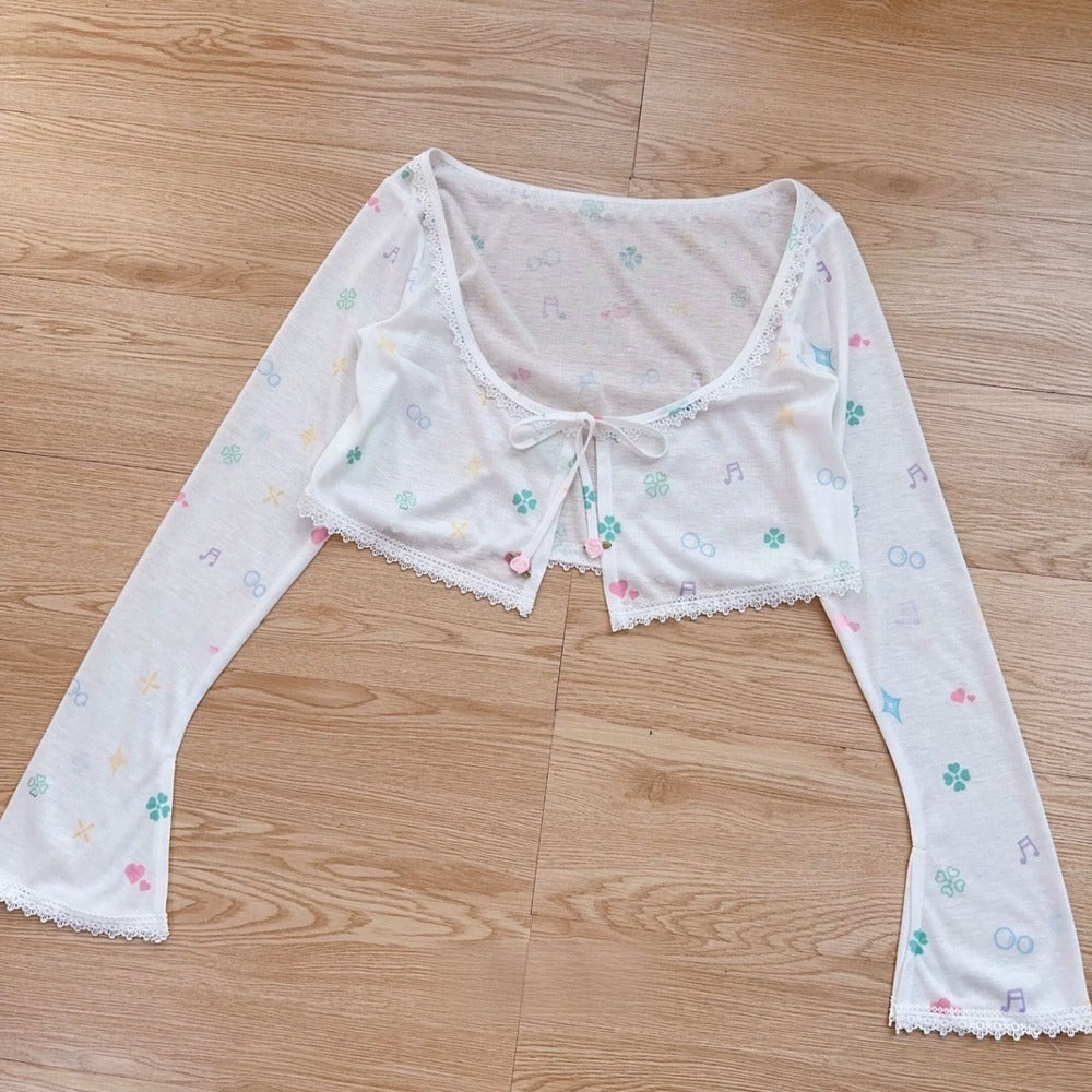 White lace top with floral patterns on a wooden floor