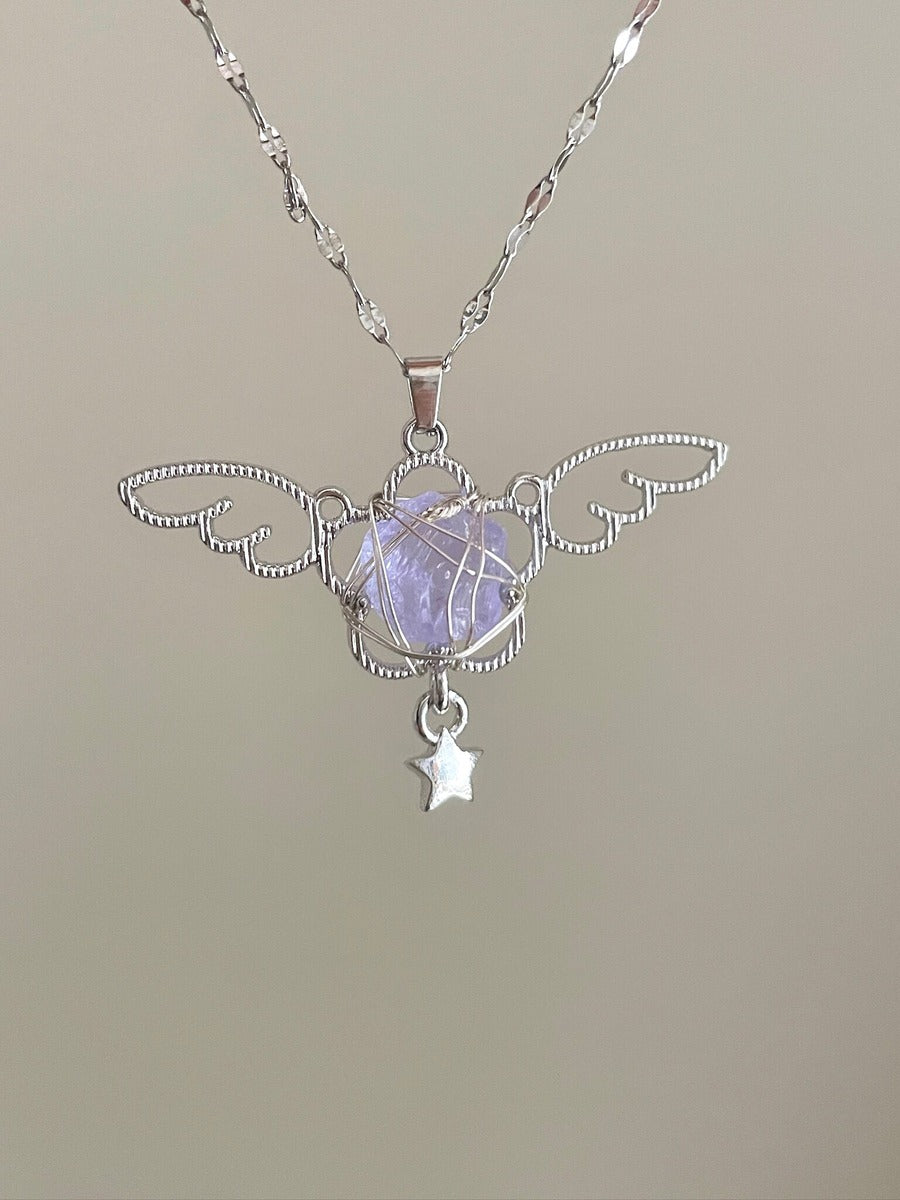 Silver pendant with a star charm on a beige background