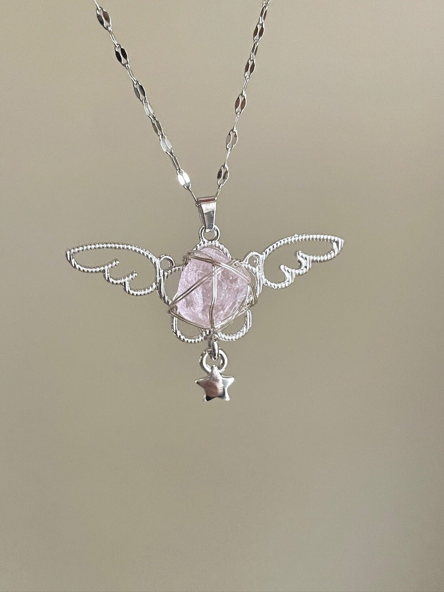 Silver necklace with a pink stone pendant on a beige background
