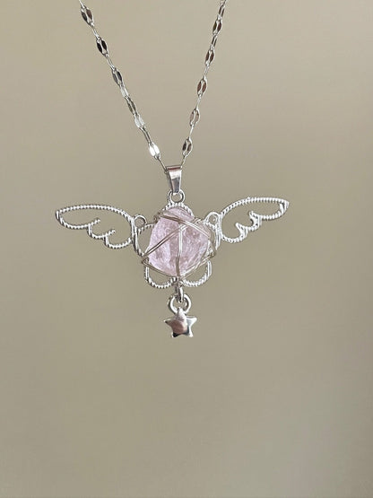 Silver necklace with a pink stone pendant on a beige background