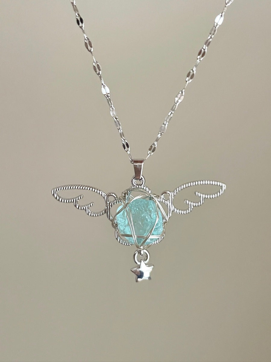 Necklace with a pendant featuring a green gemstone and silver accents on a neutral background