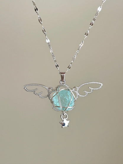 Necklace with a pendant featuring a green gemstone and silver accents on a neutral background