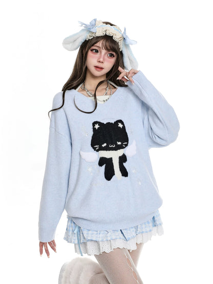 Person wearing a light blue sweater with a black cat design, white skirt, and bunny ears on a white background.