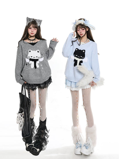 Two women wearing sweaters with cat designs on a white background