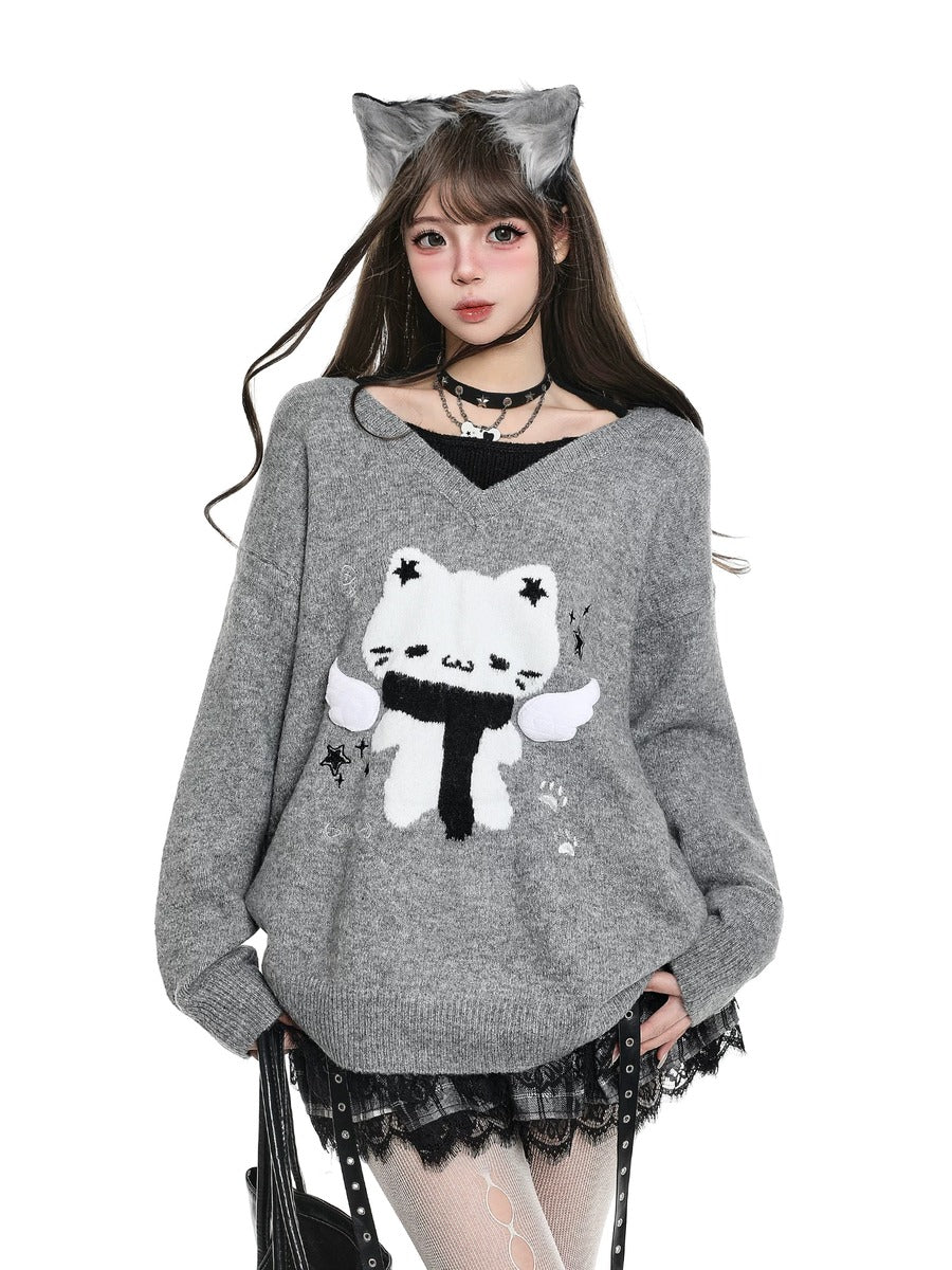 Person wearing a gray sweater with a cat design, black skirt, and cat ears on a white background