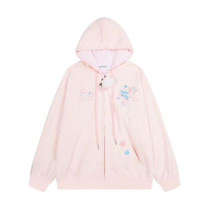 A light pink zip-up hoodie with a hood, featuring pastel embroidered designs including a unicorn, a starry sky motif, and small heart accents. The hoodie has a front zipper, drawstrings, and a white pom-pom charm.