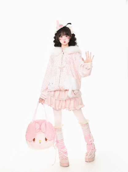 A model posing in a cute, pastel pink Lolita-style outfit featuring a polka-dot jacket with faux fur collar, a ruffled mini skirt, matching pink socks, and a pink My Melody bag against a solid white background.