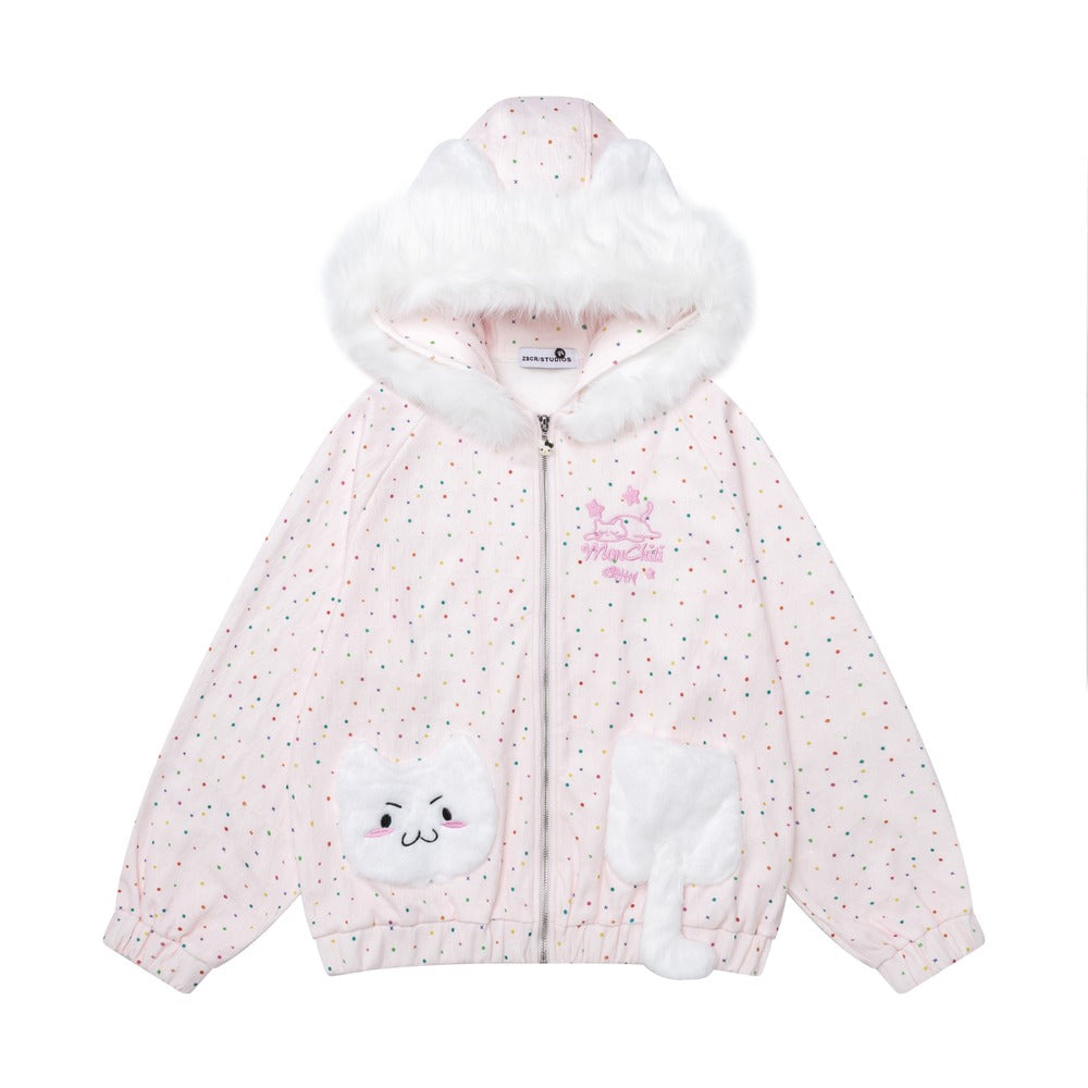 A children's zip-up hooded jacket in pale pink with tiny multicolor polka dots, a fluffy white faux-fur trimmed hood, and white cat-face patch details on the front pockets. A small pink embroidered chest graphic is visible.