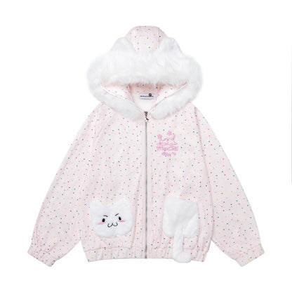 A children's zip-up hooded jacket in pale pink with tiny multicolor polka dots, a fluffy white faux-fur trimmed hood, and white cat-face patch details on the front pockets. A small pink embroidered chest graphic is visible.