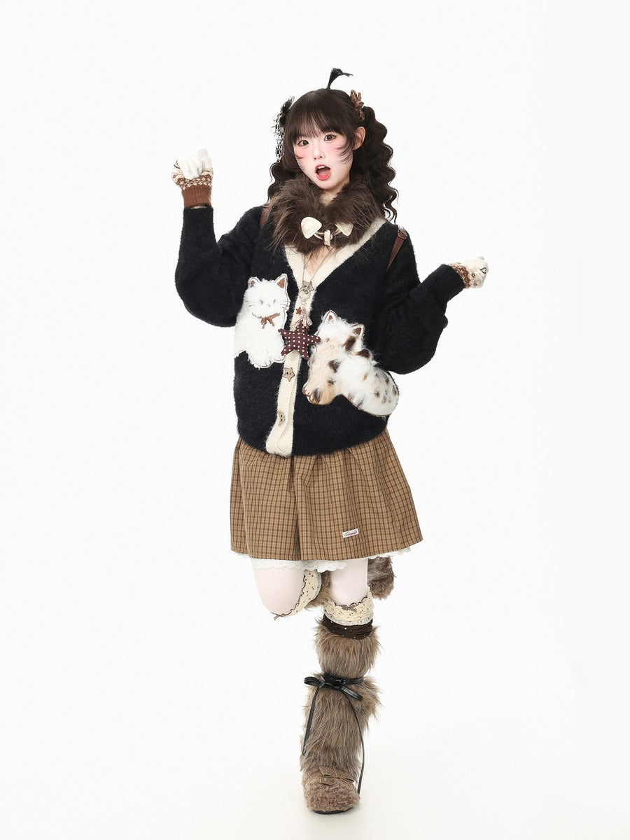 A model wearing a gothic Lolita-style outfit featuring a black cardigan with white faux-fur trim and cat prints, a brown and beige plaid pleated skirt, white thigh-high stockings, and furry boot covers, posed against a solid white background.