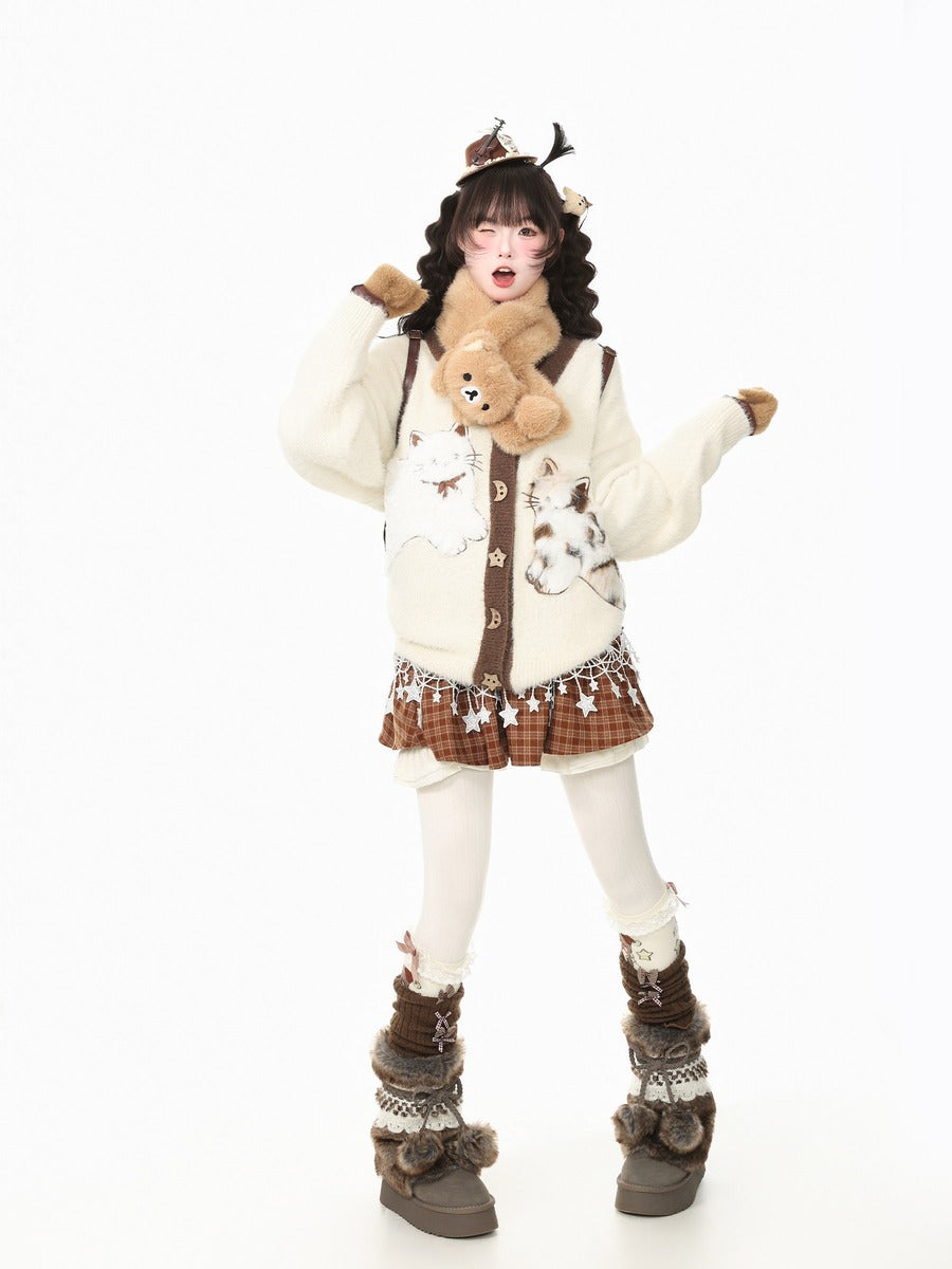 A model posing in a whimsical, Lolita-inspired outfit featuring a cream-colored cardigan with animal prints, a brown plaid mini skirt, white tights, and brown fur-trimmed boots, while holding a plush teddy bear against a solid white background.
