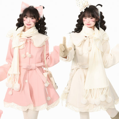 Two models wearing matching Lolita-style winter outfits, one in light pink and one in cream, both with large bow details, fringed scarves, and pom-pom accents against a plain white background.
