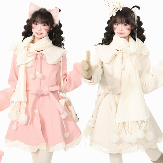 Two models wearing matching Lolita-style winter outfits, one in light pink and one in cream, both with large bow details, fringed scarves, and pom-pom accents against a plain white background.