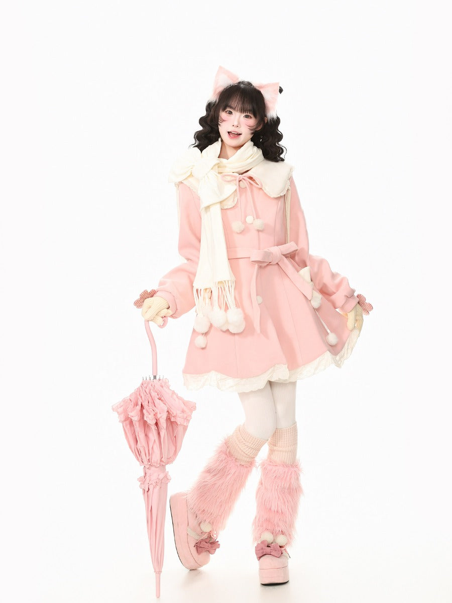 A young woman modeling a pink Lolita-style outfit with a cream scarf, fluffy pink boot covers, and holding a matching pink umbrella against a plain white background.