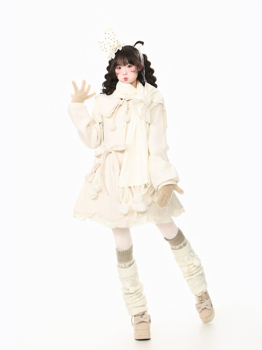 A model posing in a cream-colored Lolita-style outfit featuring a ruffled long-sleeve dress, matching scarf, beige knit leg warmers, and platform shoes against a solid white background.
