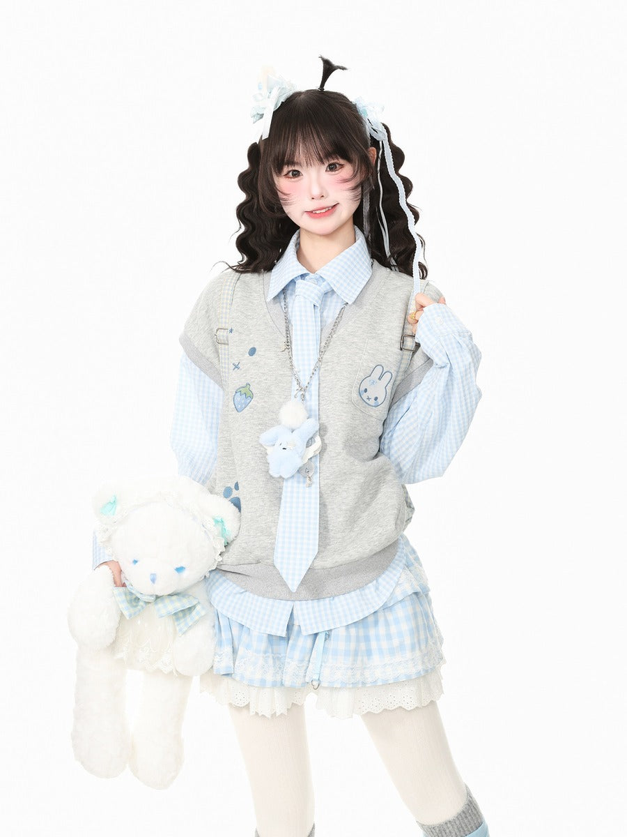 A young woman modeling a cute, pastel-themed schoolgirl outfit consisting of a light blue and white gingham shirt, a gray vest with bunny patches, a matching tie, and a pleated skirt. She is holding a white plush teddy bear against a solid white background.