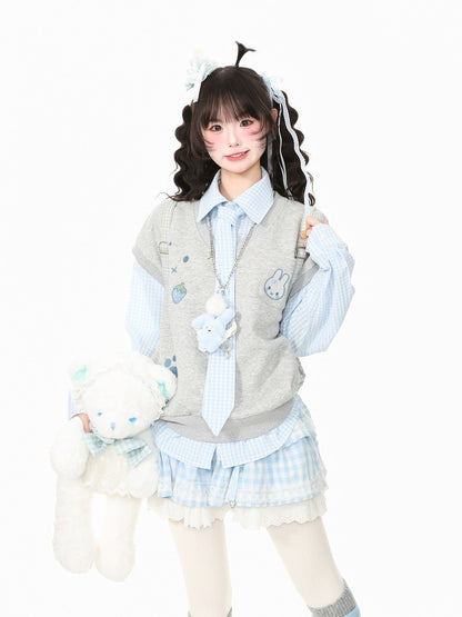 A young woman modeling a cute, pastel-themed schoolgirl outfit consisting of a light blue and white gingham shirt, a gray vest with bunny patches, a matching tie, and a pleated skirt. She is holding a white plush teddy bear against a solid white background.