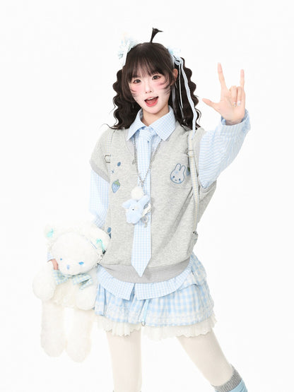 A young woman posing in a light blue and white checkered school uniform outfit with a gray vest, holding a white plush teddy bear against a solid white background.