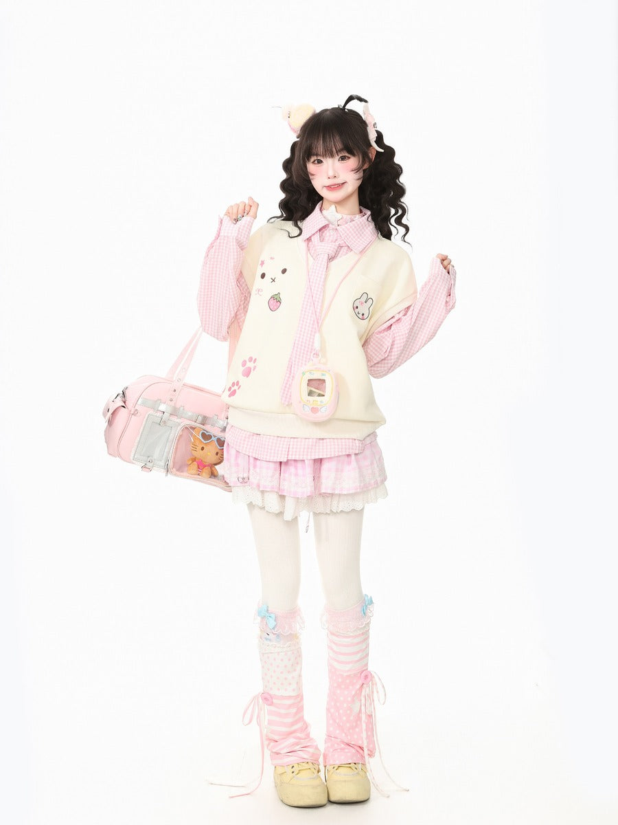 A young woman models a cute, pastel-themed outfit consisting of a cream and pink bunny cardigan, a pink striped shirt, a pink pleated skirt, white tights, pink leg warmers, and a matching pink cat backpack, set against a plain white background.