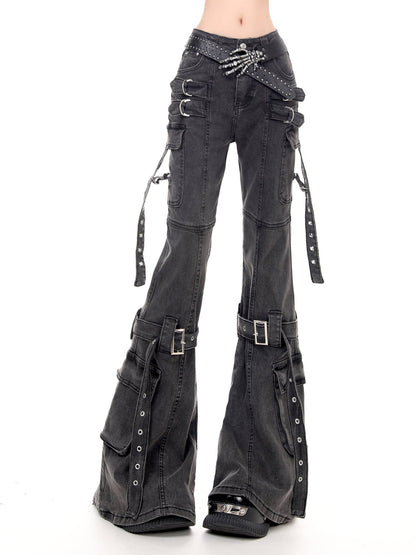 Black washed denim flare pants with multiple utility pockets, buckle straps, and studded details, shown on a model against a white background.