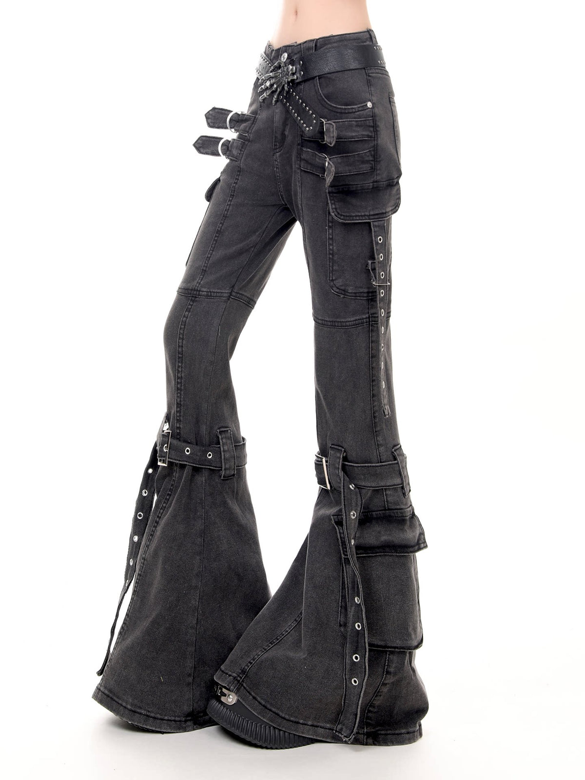Black washed denim flare pants with multiple cargo pockets, silver-tone hardware, and decorative straps, shown on a model against a white background.