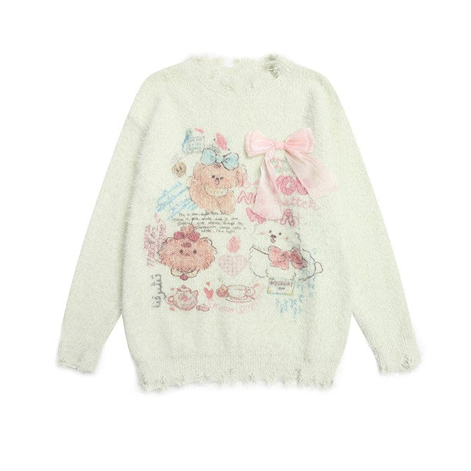 A pale mint green fuzzy knit sweater with a distressed frayed hem, featuring a cute cartoon bear graphic and a large pink bow on the front, displayed against a solid white background.