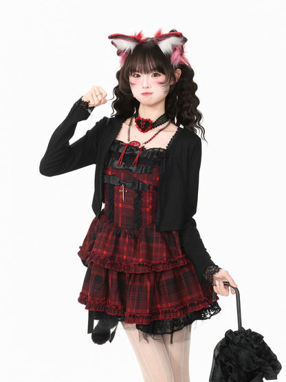 A model wearing a gothic Lolita-style outfit consisting of a red and black plaid corset dress, a black cardigan, a red rose choker, and pink and white fox ears headband, holding a black ruffled umbrella against a white background.