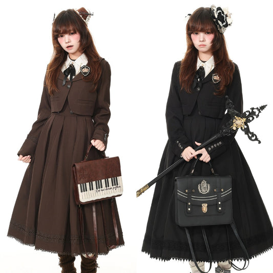 Two models wearing Victorian-style Lolita dresses, one in dark brown and one in black, both featuring long pleated skirts, structured jackets, white collars, and black bows. The model on the left holds a brown piano-key handbag, and the model on the right holds a black decorative staff with a matching black satchel.