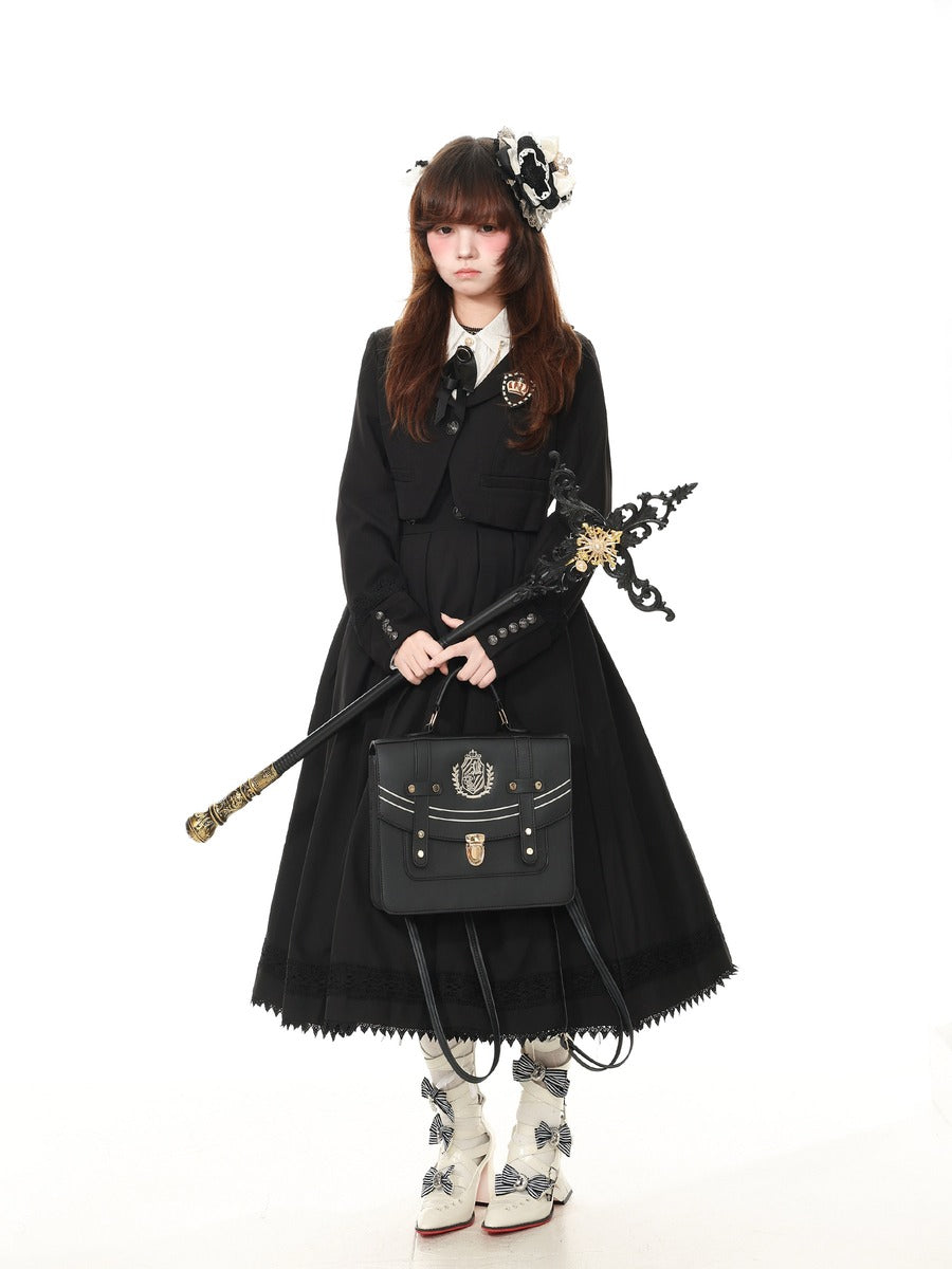 A model wearing a black Victorian-style Lolita dress with a white collar, holding a black decorative staff and a matching black handbag, set against a plain white background.