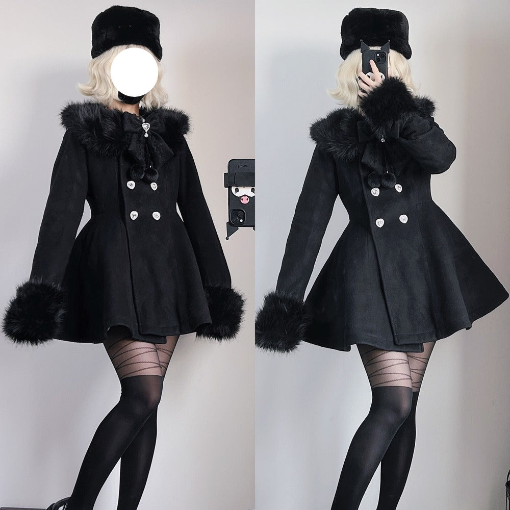 A split-view mirror selfie showing a model wearing a short black coat with a large black fur-trimmed collar, matching black hat, black tights, and striped stockings against a plain indoor wall.