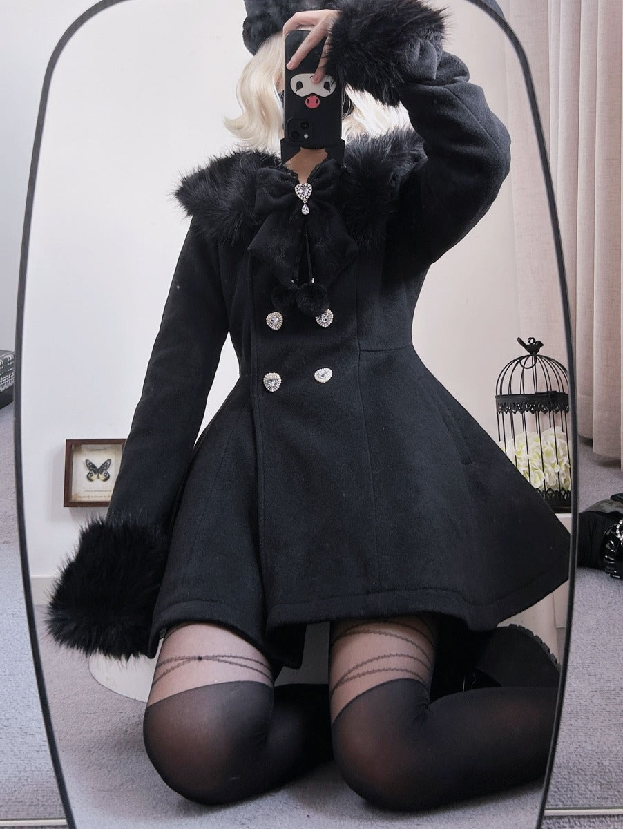 A person takes a mirror selfie wearing a black winter coat with fluffy trim, a matching black hat, and black thigh-high stockings in an indoor room.