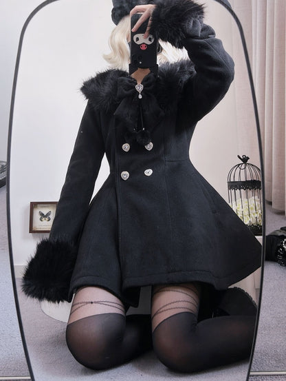 A person takes a mirror selfie wearing a black winter coat with fluffy trim, a matching black hat, and black thigh-high stockings in an indoor room.