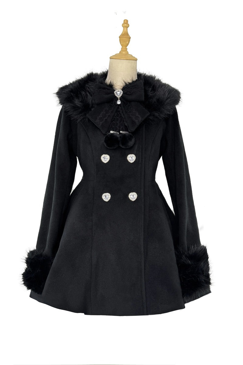 A black double-breasted coat with faux fur trim on the collar and cuffs, displayed on a dress form mannequin against a white background.