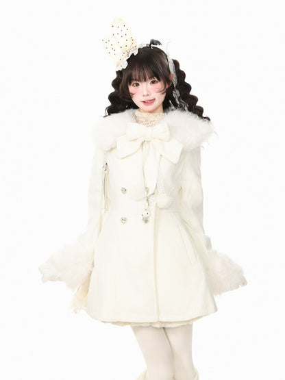 A young woman modeling a cream-colored Lolita-style coat with a large bow on the collar, fluffy ruffle cuffs, and matching cream tights, set against a solid white background.