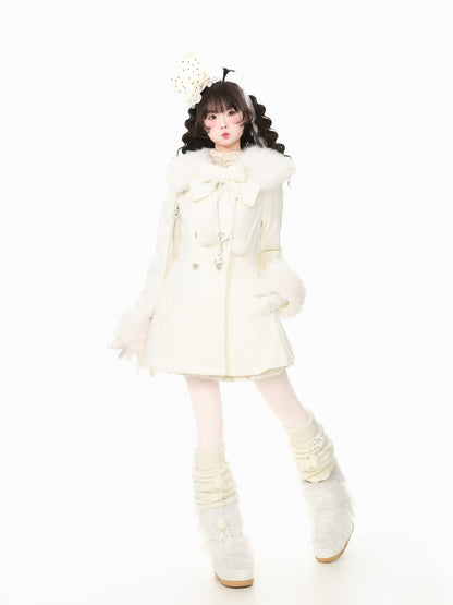 A young girl modeling a cream-colored winter outfit consisting of a short coat with a large bow, fluffy collar, matching mittens, a decorative headpiece, and fluffy lace-up boots, set against a solid white background.
