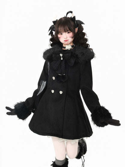 A person modeling a black double-breasted coat with a large black faux-fur collar, black gloves, and black hair accessories with cat-ear details, posed against a plain white studio background.