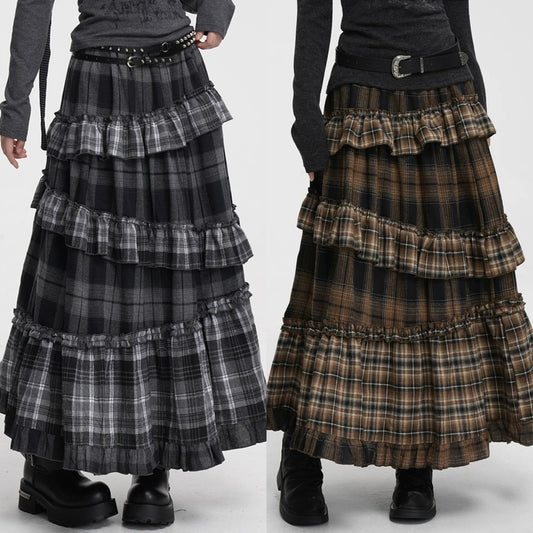 Two gothic-style tiered ruffle maxi skirts with plaid patterns, shown side-by-side on a model. The left skirt is black and gray, and the right skirt is brown and black.