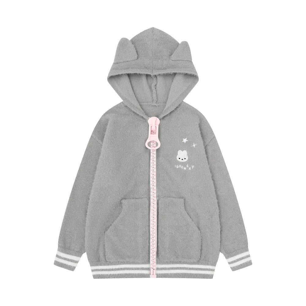 A children's gray zip-up hoodie with a plush texture, featuring cat-ear shaped hood, a pink zipper pull, a small cartoon bunny graphic on the left chest, and striped ribbed cuffs and hem.