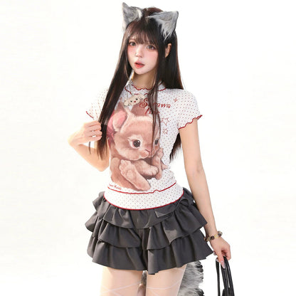 Woman wearing a shirt with a bear design and gray shorts on a white background