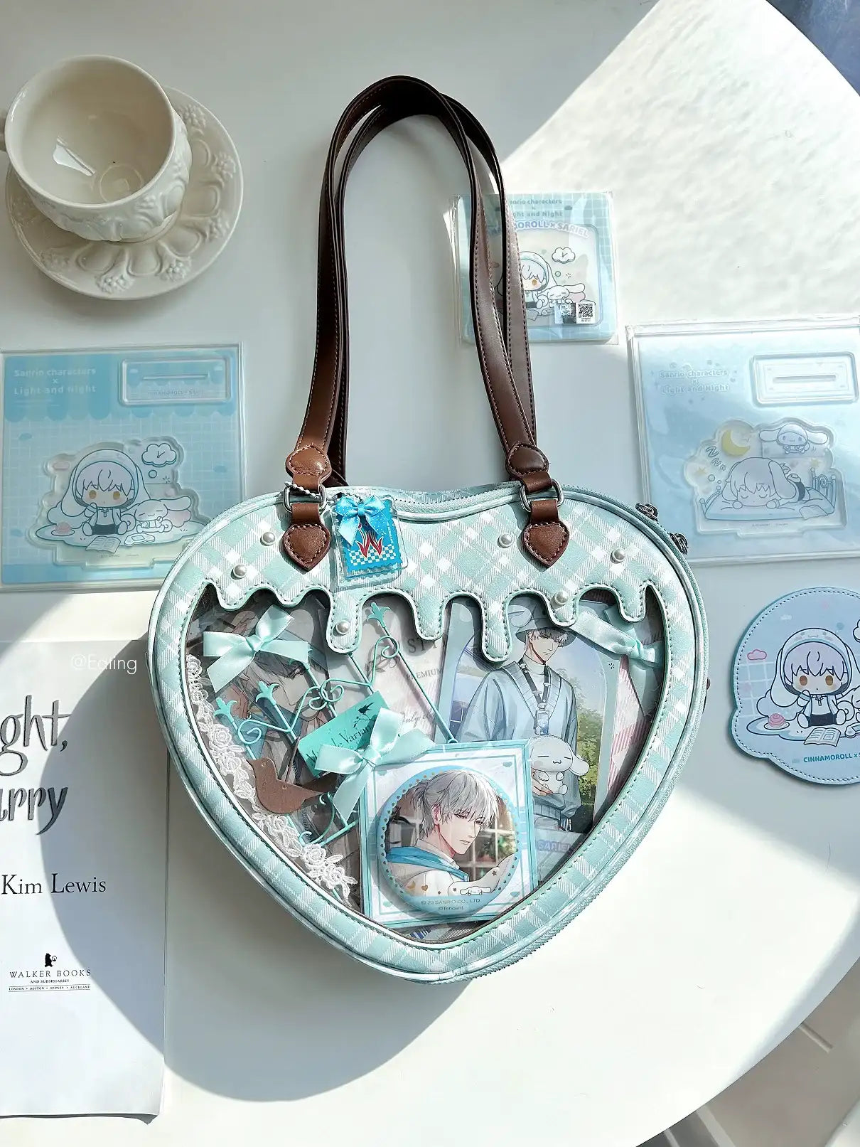 Heart-shaped handbag with character illustrations on a light surface