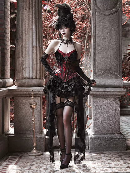 Woman in a gothic-style outfit standing in an elegant outdoor setting with classical architecture.