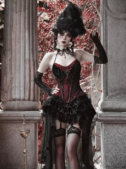 Woman in a gothic-style outfit with a black hat and red corset standing in an ornate setting.