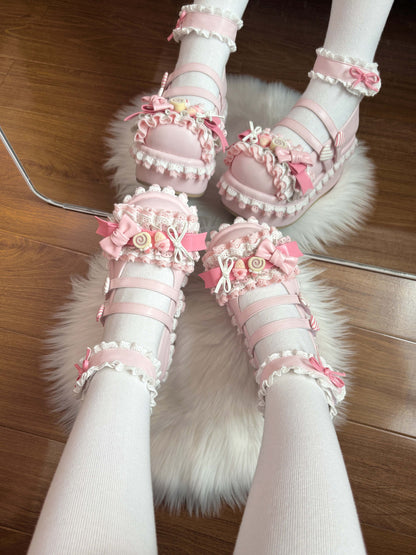 Pink wedge shoes with floral decorations on a fluffy white rug.