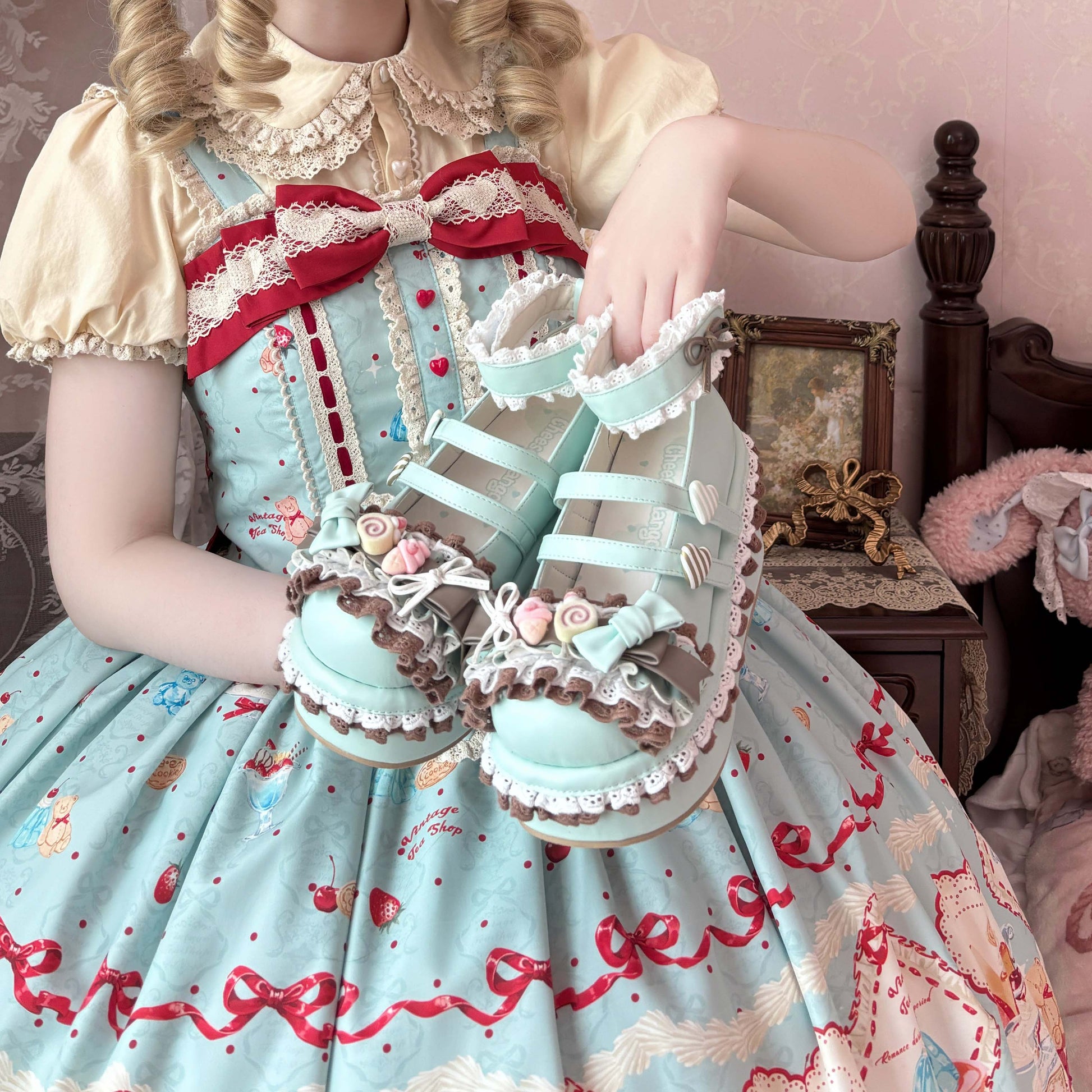Person wearing a detailed dress with a red bow and lace accents, standing in a room with a bed and framed picture.