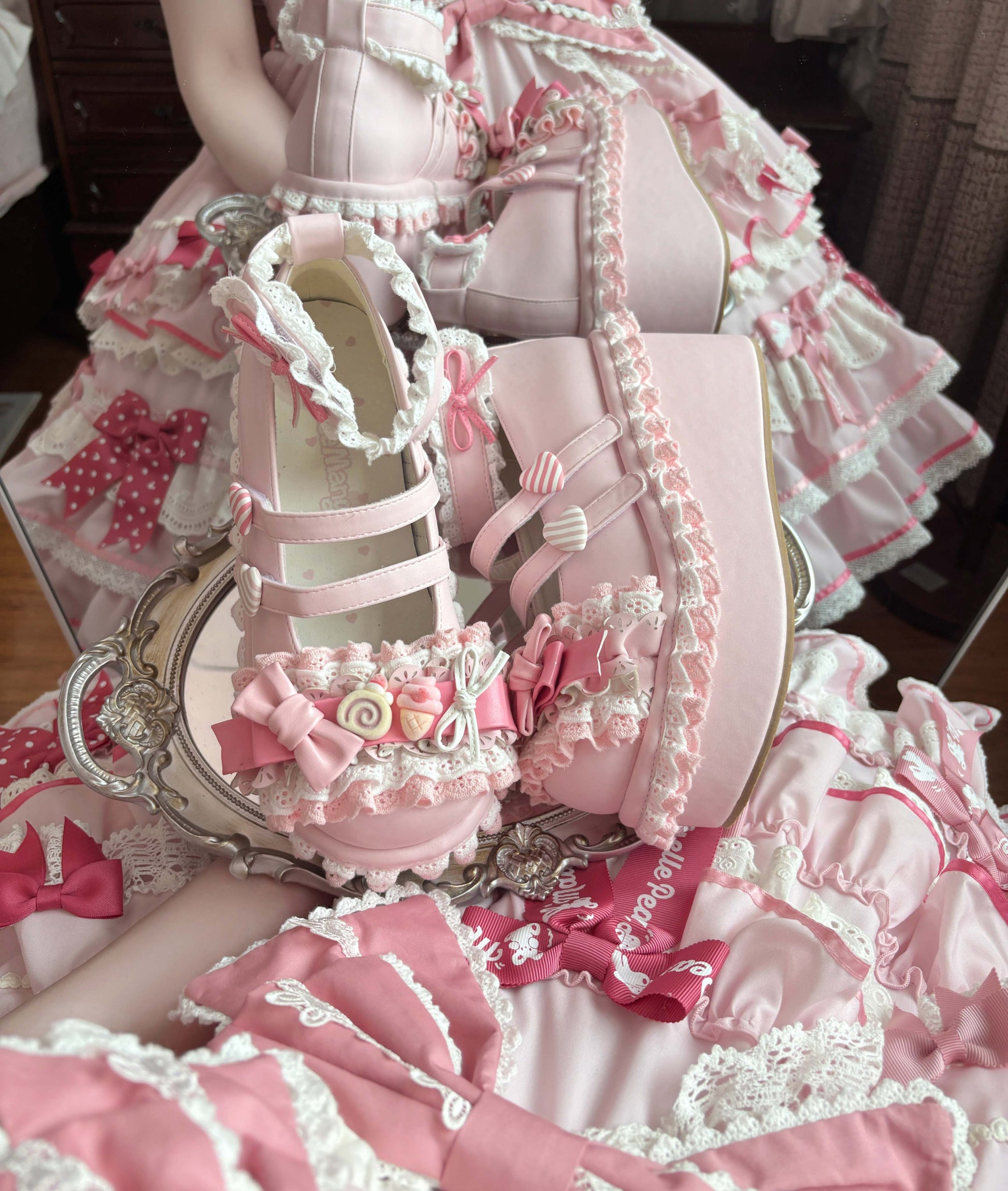 Detailed view of a pink and white lace-up shoe with decorative elements.