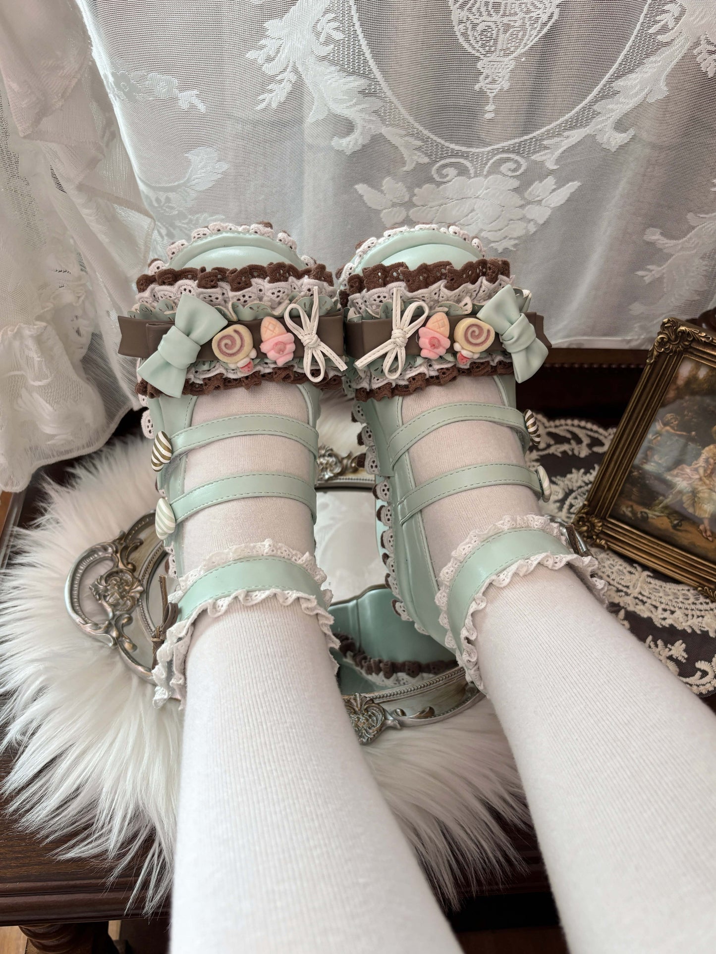Decorative shoes with floral embellishments and lace details on a white background.