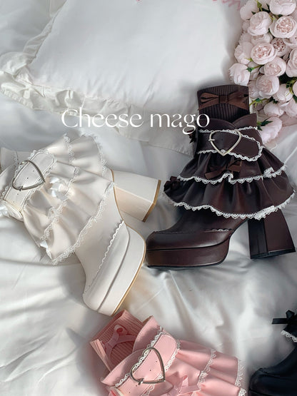 Pair of ruffled shoes on a white surface with 'Cheese mago' branding.