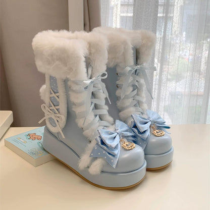 Light blue boots with white fur and decorative bows on a neutral background